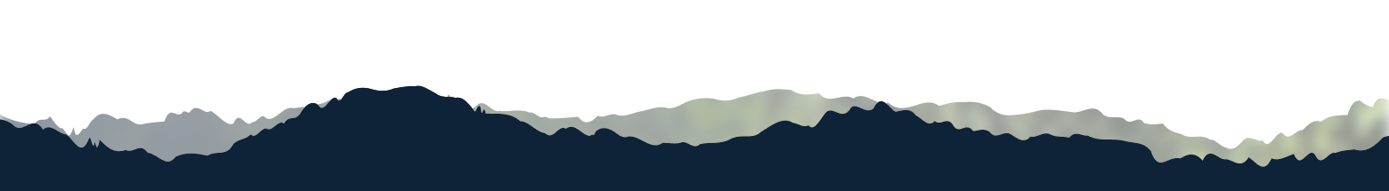 Silhouette of mountain range with layered peaks under a clear sky.