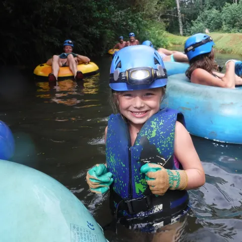 a group of people sitting on a raft in a pool of water
