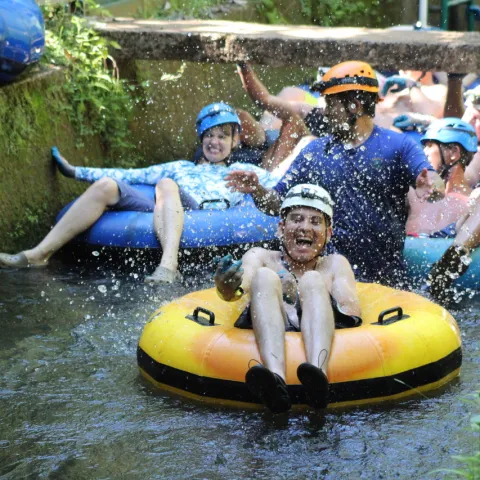 a group of people on a raft in a pool of water