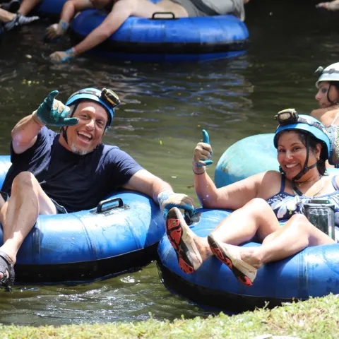 a group of people on a raft in a body of water