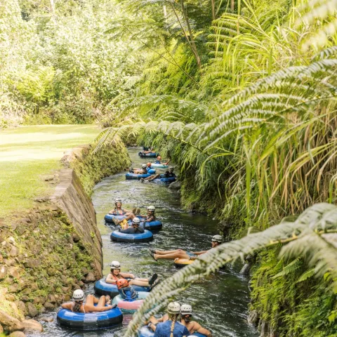 a group of people in a boat on a river