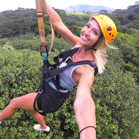 a woman wearing a helmet posing for the camera