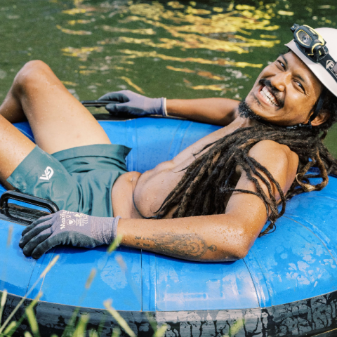 a person lying on a raft in a body of water
