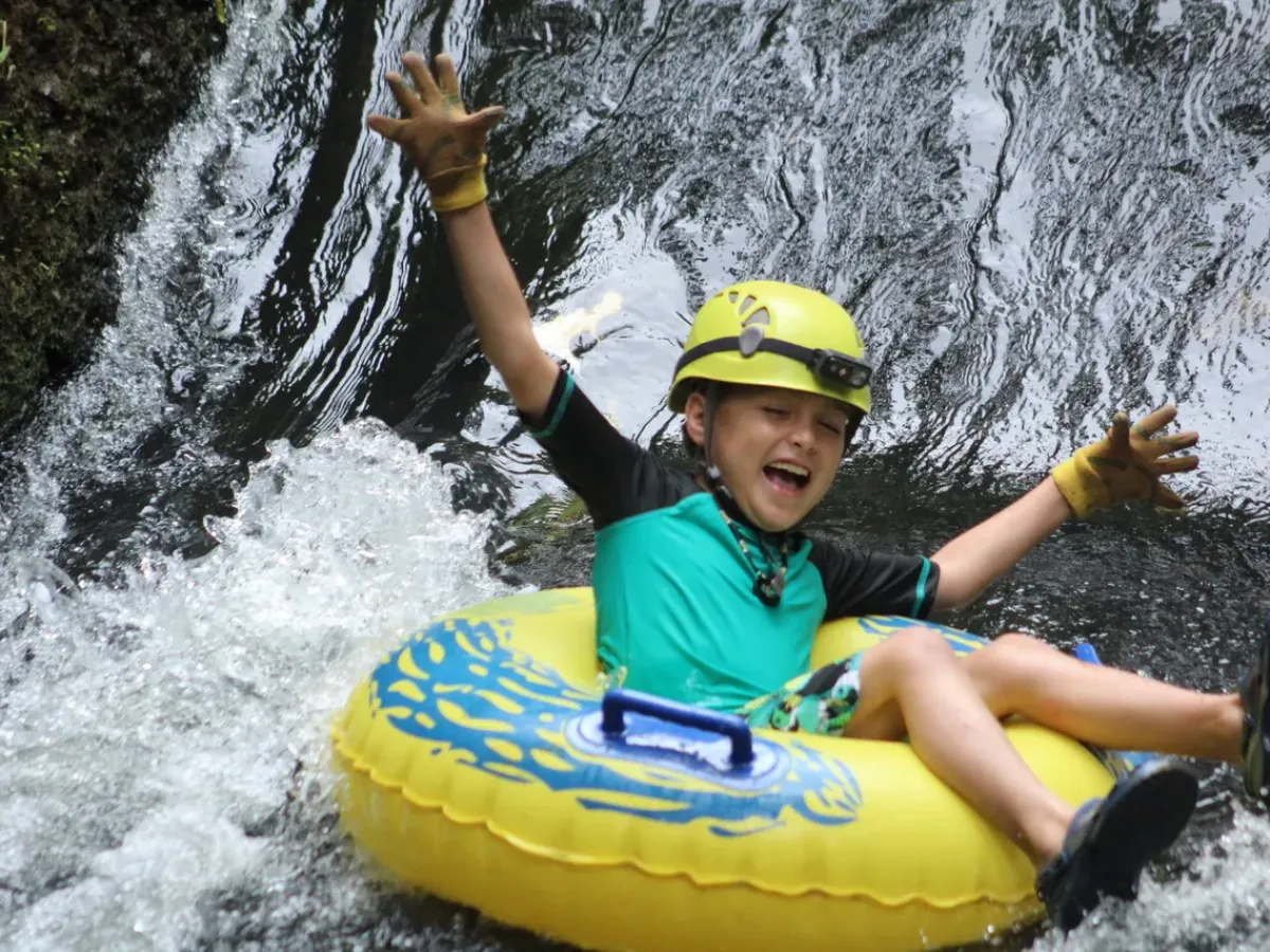 a young girl riding a wave on a surfboard in the water