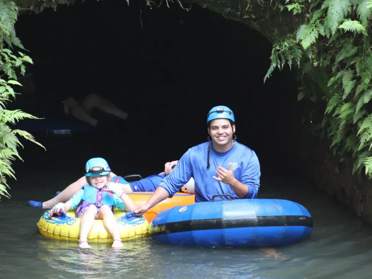a man in a blue shirt riding on a raft