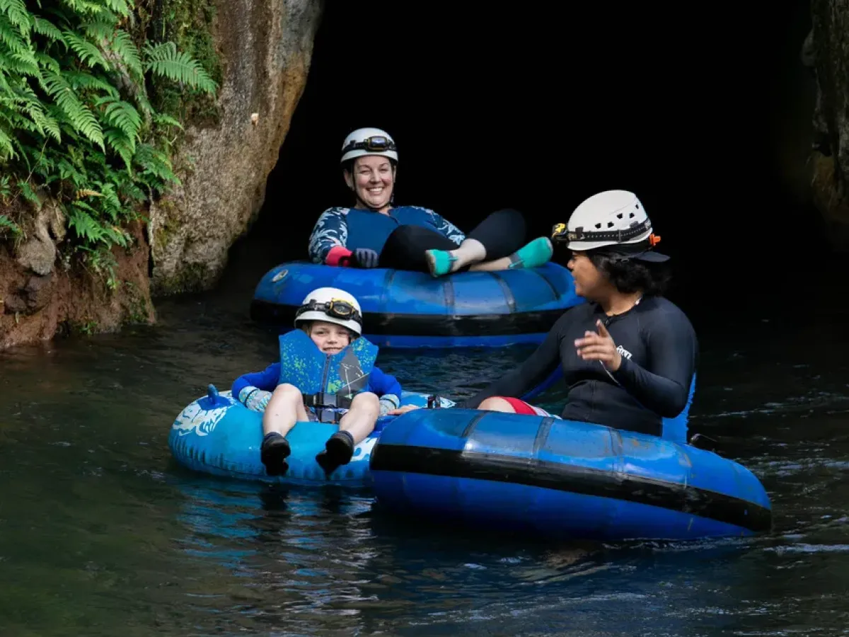 a group of people riding on a raft in a body of water