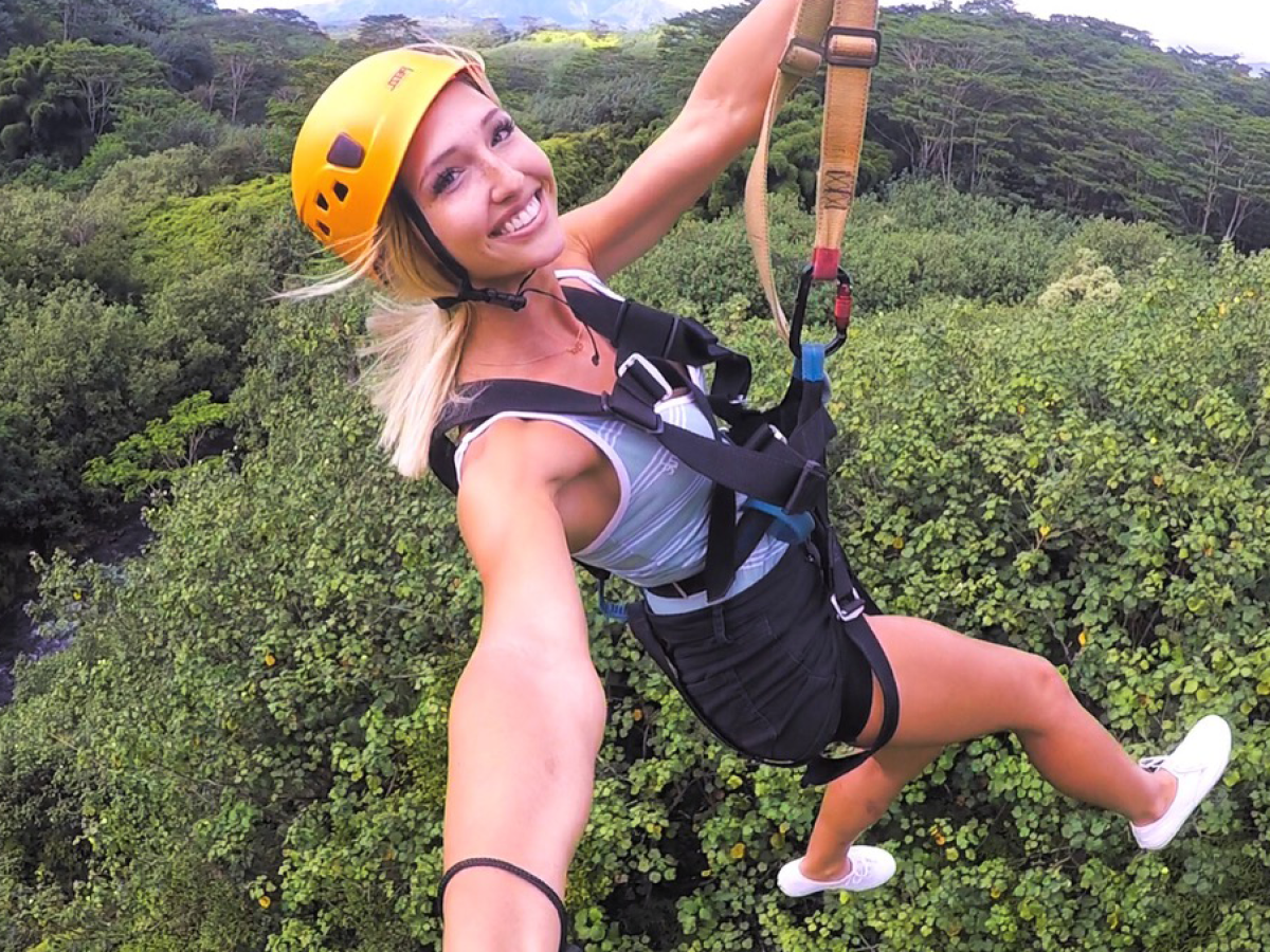 a woman wearing a helmet posing for the camera
