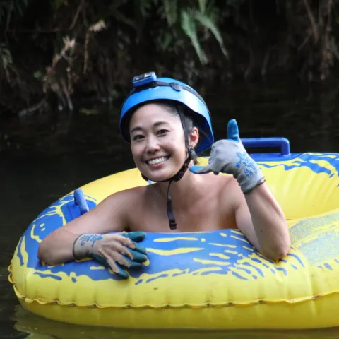 a young child riding on a raft in a pool of water