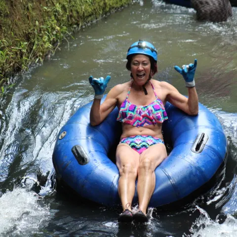 a woman sitting on a raft in a body of water
