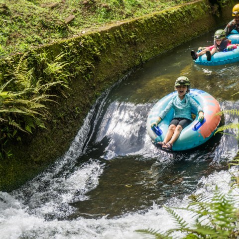 a man riding on a raft in a body of water