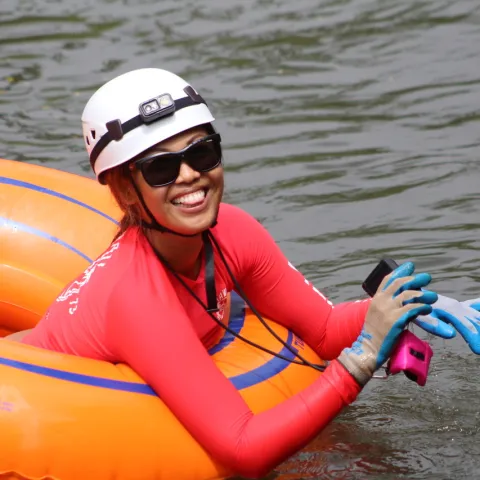 a woman sitting on a boat in a body of water