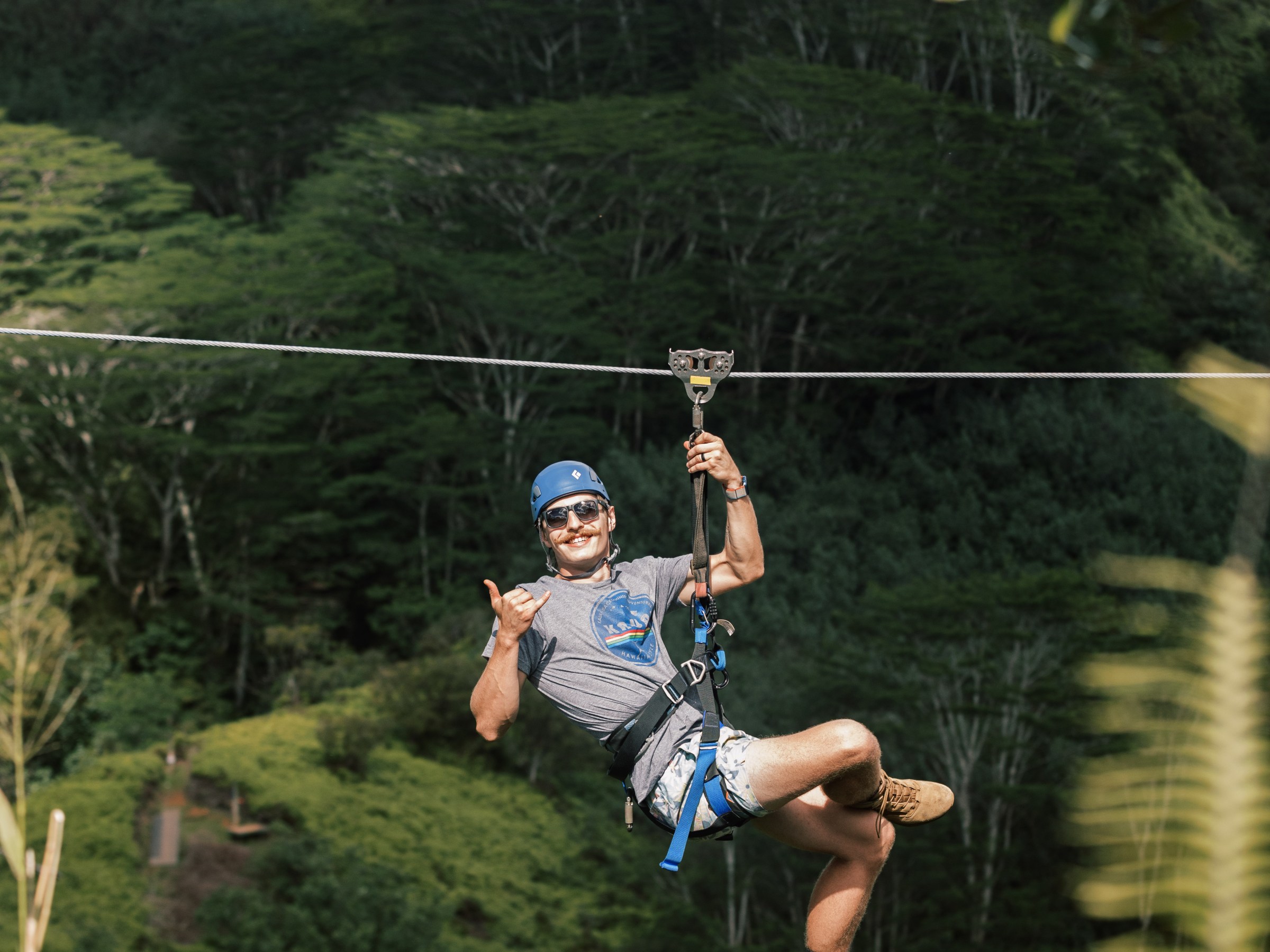 a man flying through the air on top of a mountain
